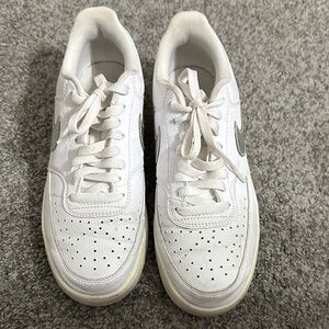 Nike White Low-Top Sneakers with Silver Swoosh Accent